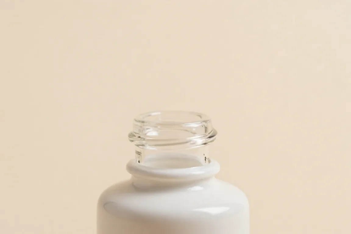 Macro shot of cosmetic bottle packaging showing the period after opening expiration symbol.